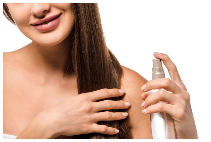 Woman using hairspray by LightField Studios | www.shutterstock.com