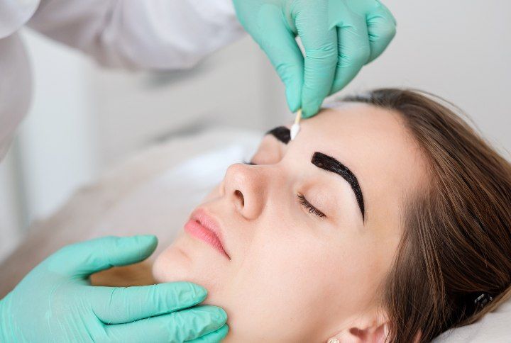 Beautician Performing Eyebrow Tint by Nejron Photo | www.shutterstock.com