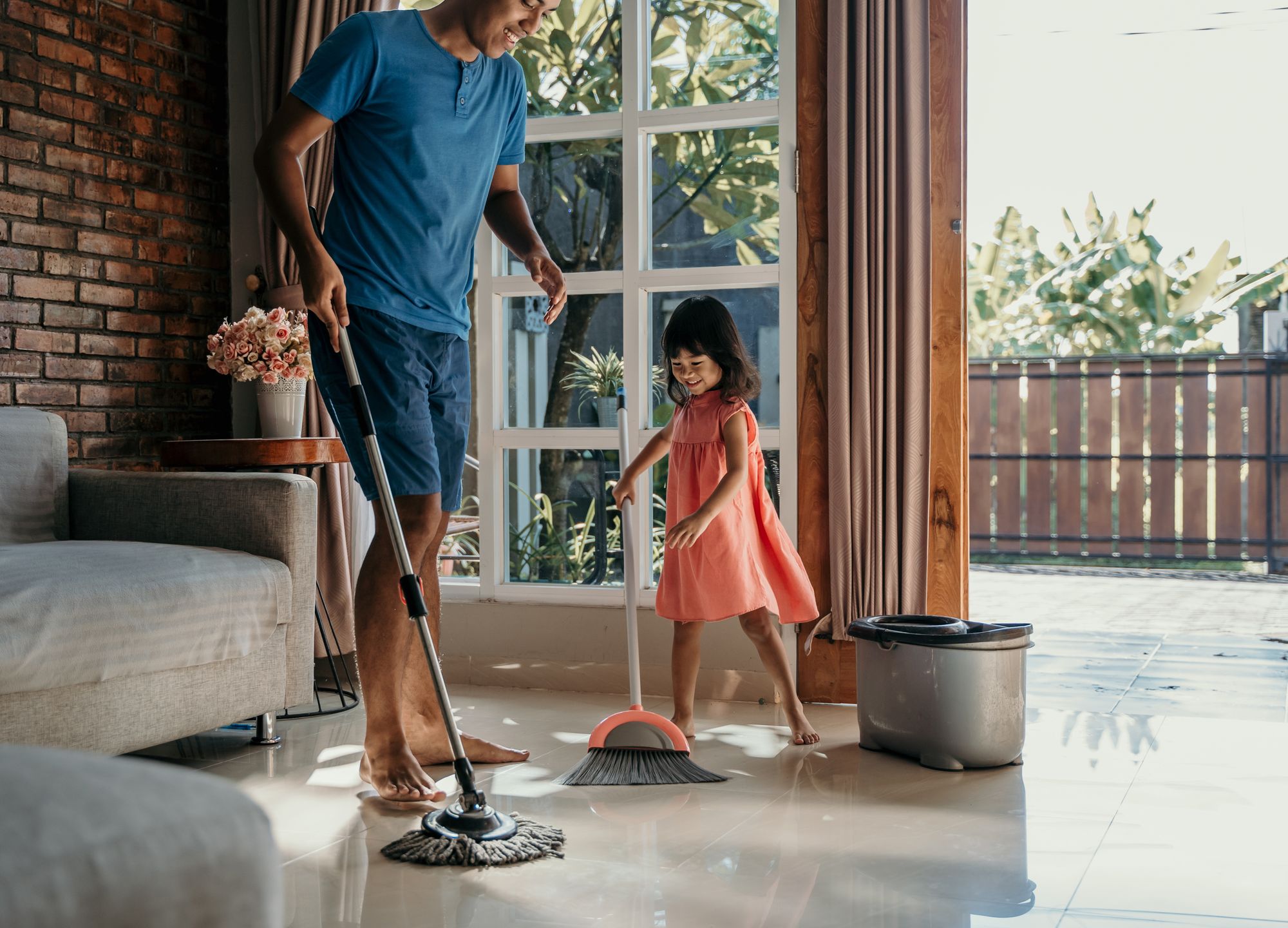 Father And Daughter Doing Chores Together | Odua Images