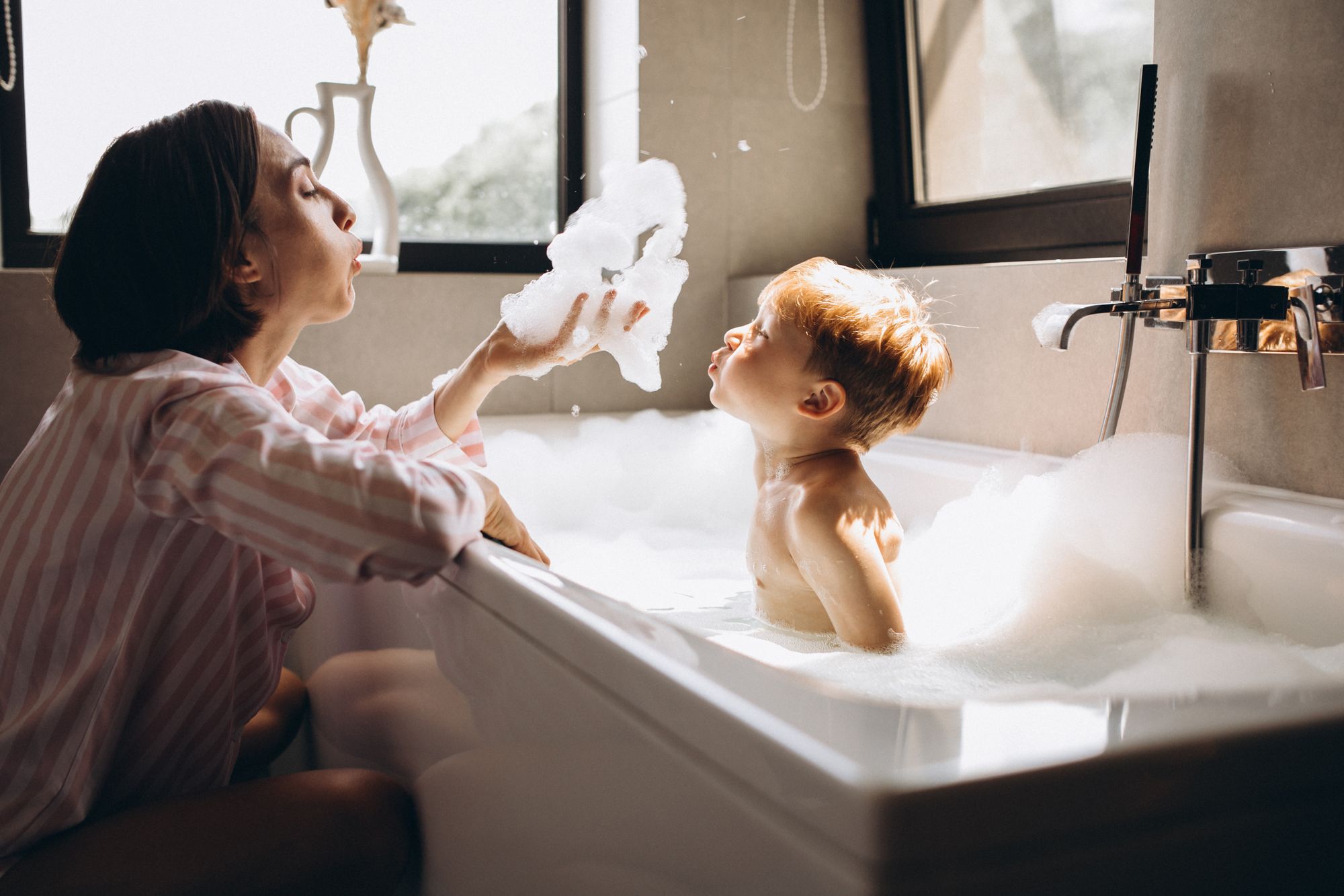 Kid bathing with parent by PH888 | www.shutterstock.com