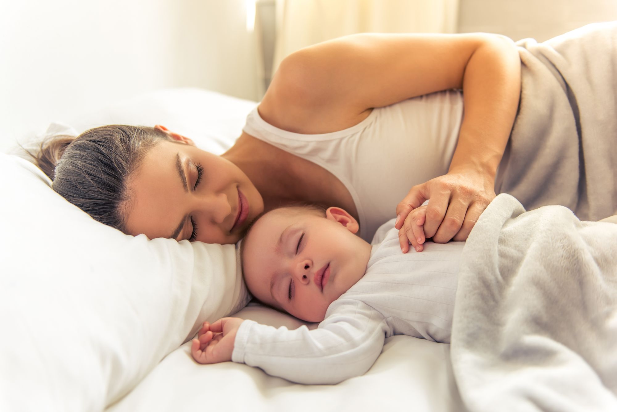 Mom And Baby Sleeping Together by George Rudy | www.shutterstock.com