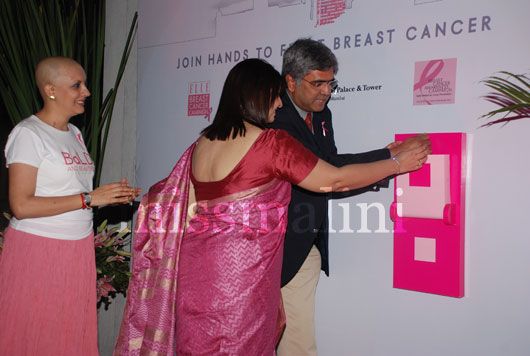 Breast cancer survivors Jyoti & Gopa illumiante the building with Dr. Rajendra