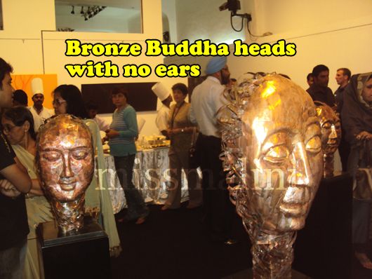 Large bronze sculptures of Buddha heads were placed around the room