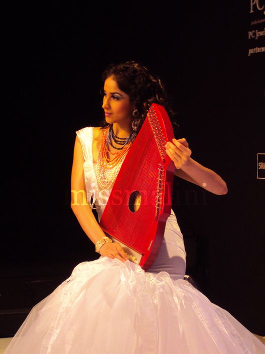 A model played the harp as models walked the ramp at the Eekani show