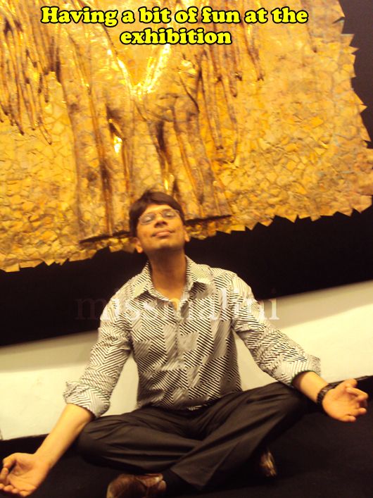 Meditating under a bronze sculpture