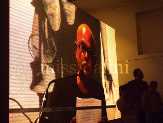 Prabhakar Kolte's image on an LED screen as he speaks to the audience